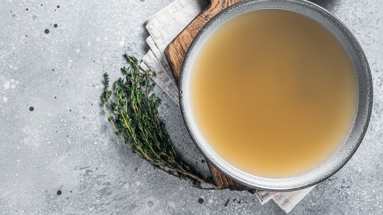 Bowl of broth with herbs
