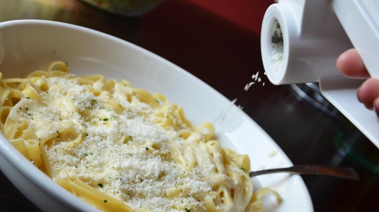 grated cheese over pasta