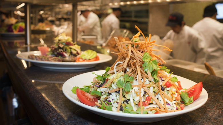 two salads on the line in restaurant kitchen
