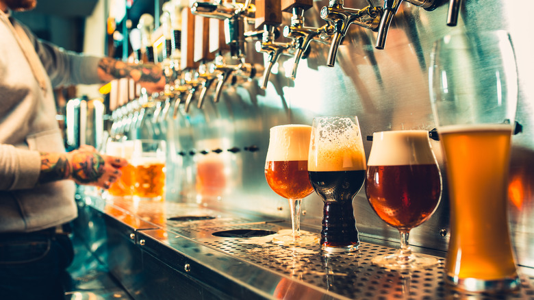A lineup of different beers on a bar