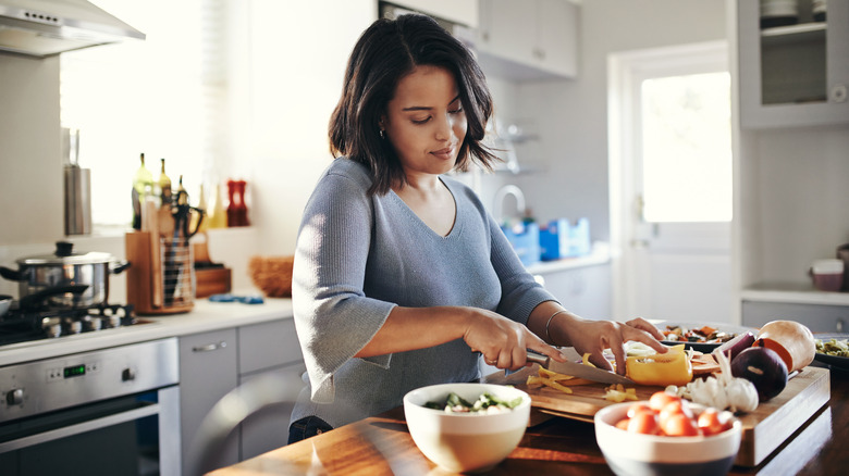 Woman chopping a bell pepper