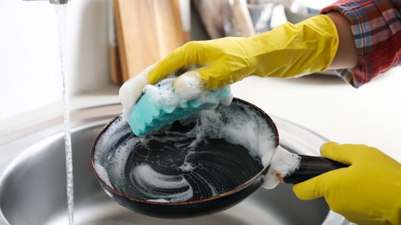 frying pan being washed