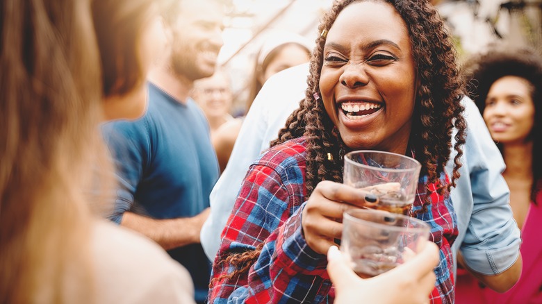 two women drinking and laughing