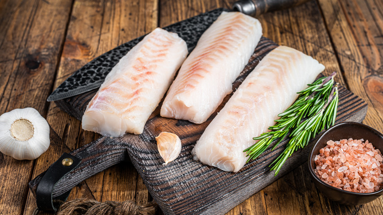 Raw cod on cutting board