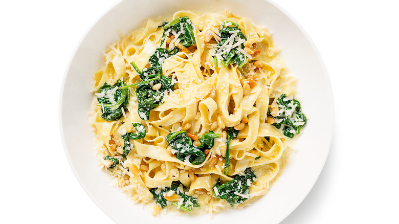 Fettuccine pasta with cooked spinach