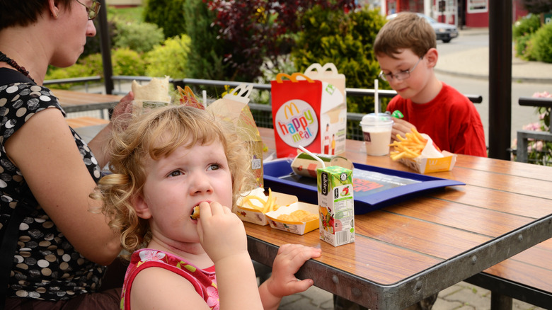 Family with kids eating at McDonald's