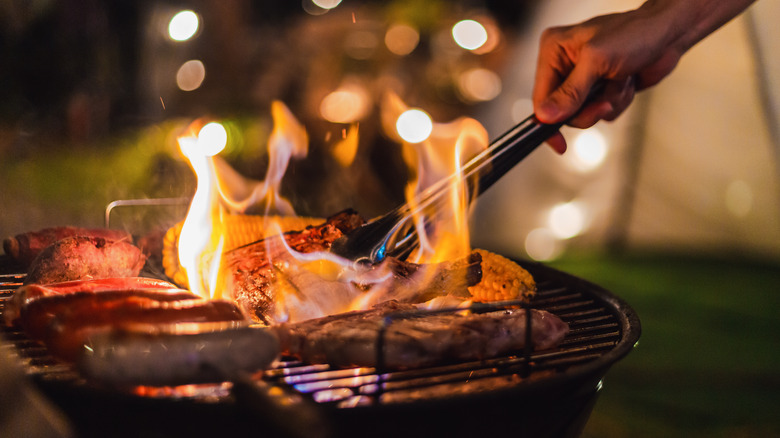 Barbecuing meat on a grill 