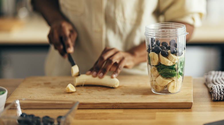 Person using wooden cutting board