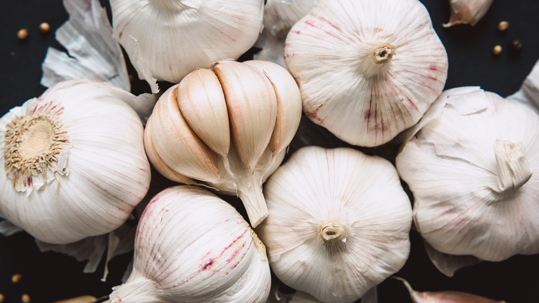 partially peeled heads of garlic