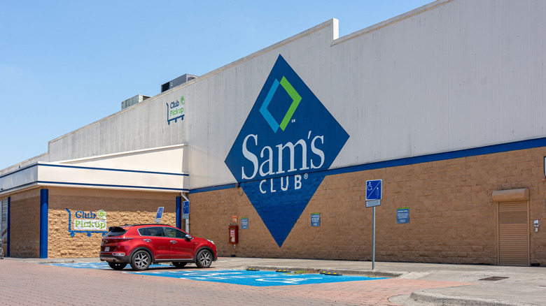 One red SUV parked outside of a Sam's Club