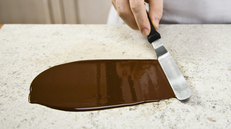 Spreading chocolate with a palette knife