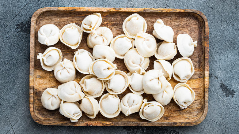 Frozen tortellini on a wooden tray