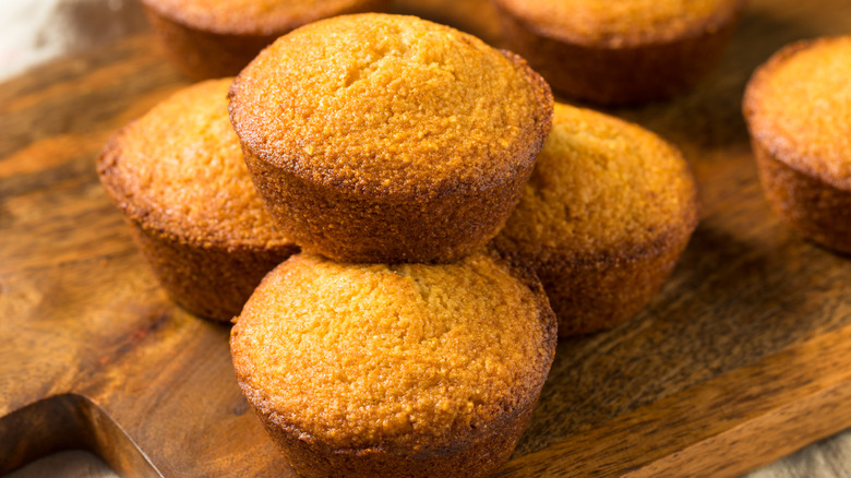 Cornbread muffins stacked on board