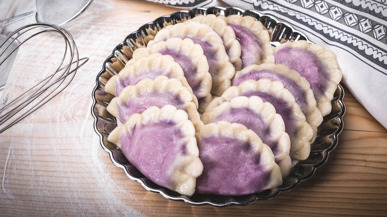 Berry-filled pierogi in a metal dish