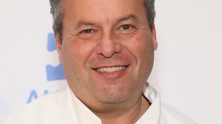 Michael Ginor with white button down and wide smile