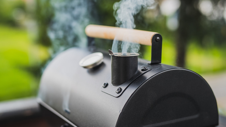 Smoker outdoors giving off smoke