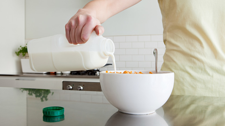 pouring milk into cereal bowl
