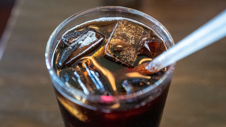 glass of dr pepper with straw inside