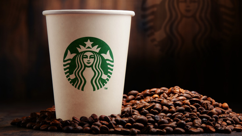 Starbucks cup with coffee beans