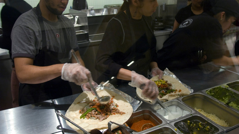 Chipotle employees preparing burritos