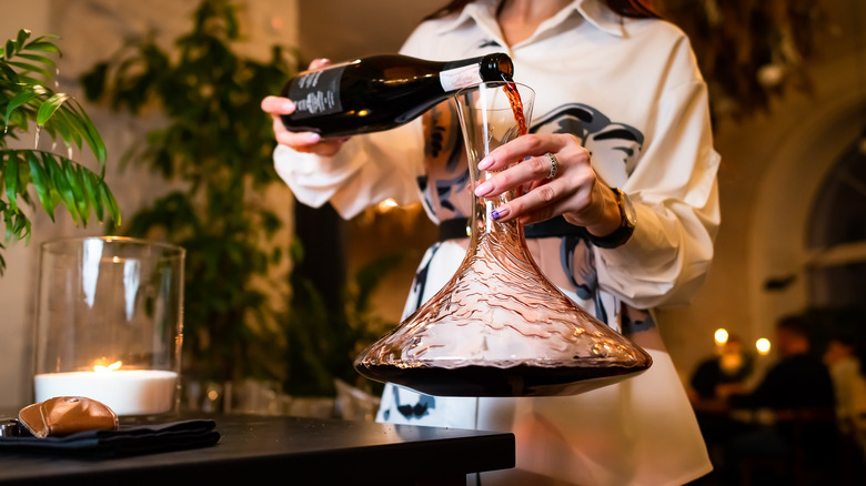 Woman decanting red wine