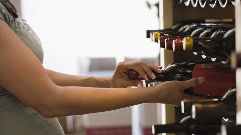 Person holding wine bottle