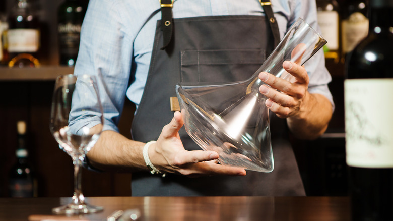 Man holding empty decanter