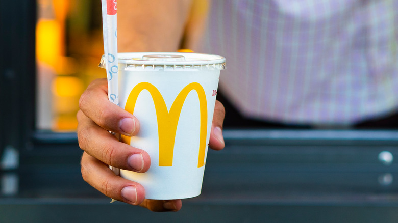 McDonald's employee holding drink