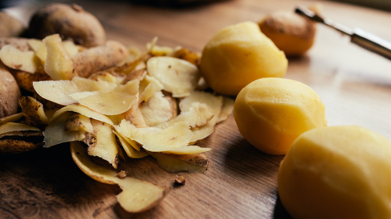 Peeled potatoes on a cutting board