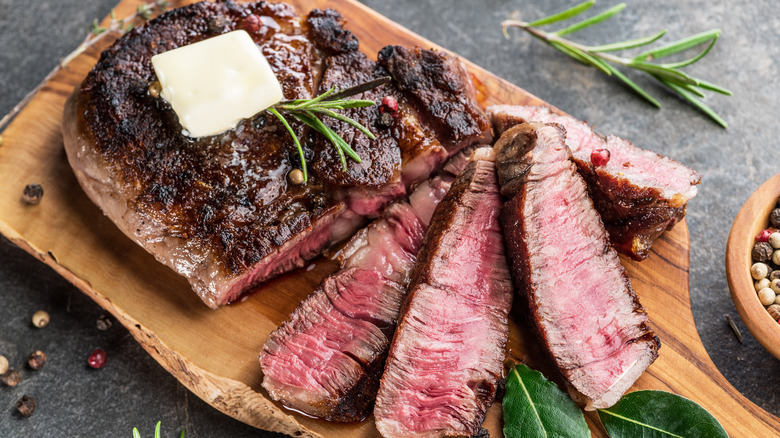 ribeye steak sliced on cutting board