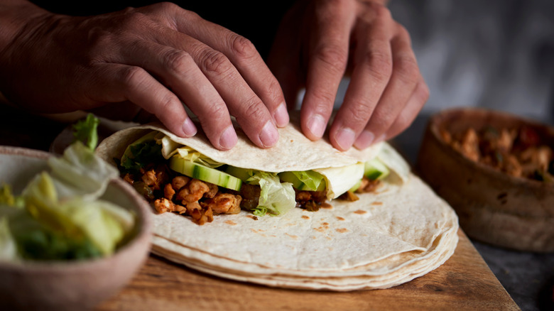 Person rolling burrito