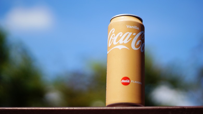 vanilla coke against a blue background