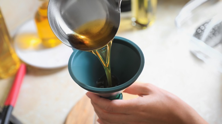 oil pouring into funnel