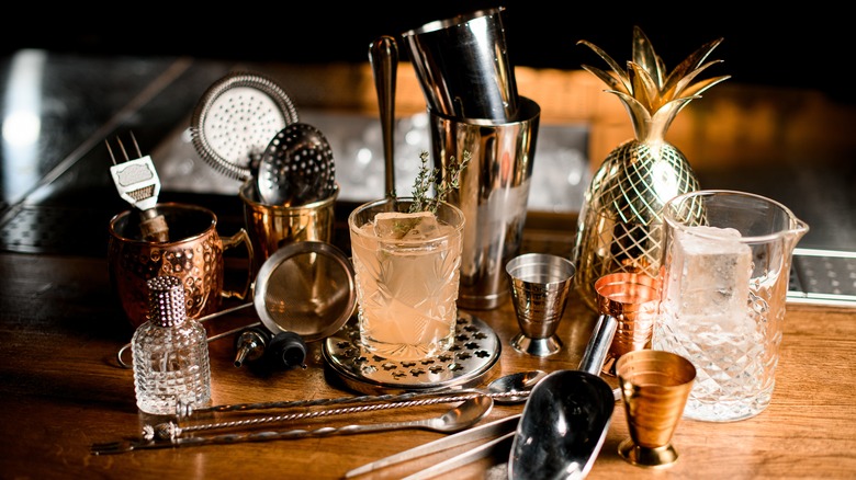 A collection of bar tools on wooden table