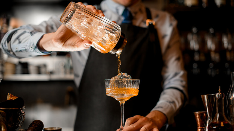 A bartender mixes a drink