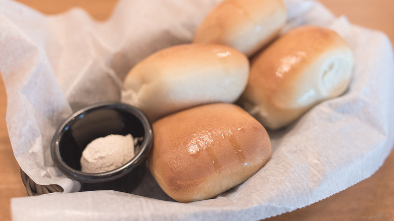 Texas Roadhouse hand-made dinner rolls with honey cinnamon butter in a basket