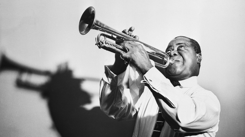 Louis Armstrong blowing a trumpet