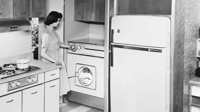 1950s woman demonstrating new kitchen technology