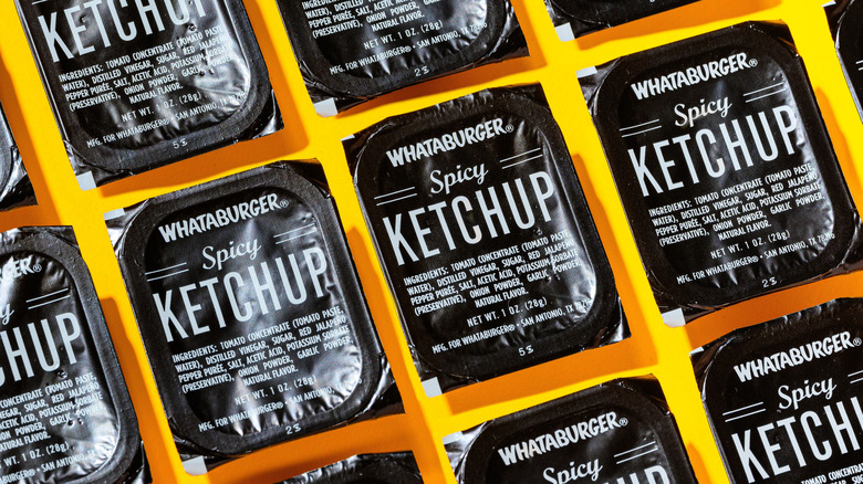 A grid pattern of single-serve Whataburger spicy ketchup tubs