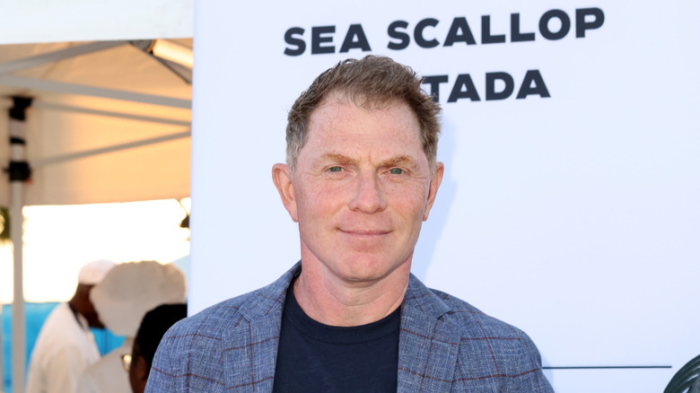 Bobbly Flay wearing a black shirt and patterned blazer.