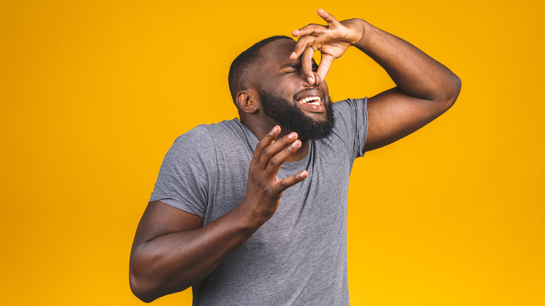 Man holding his nose