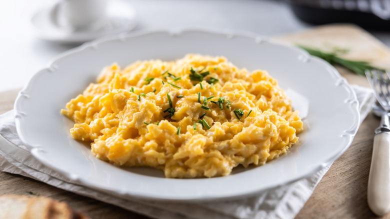 scrambled eggs with chives on plate