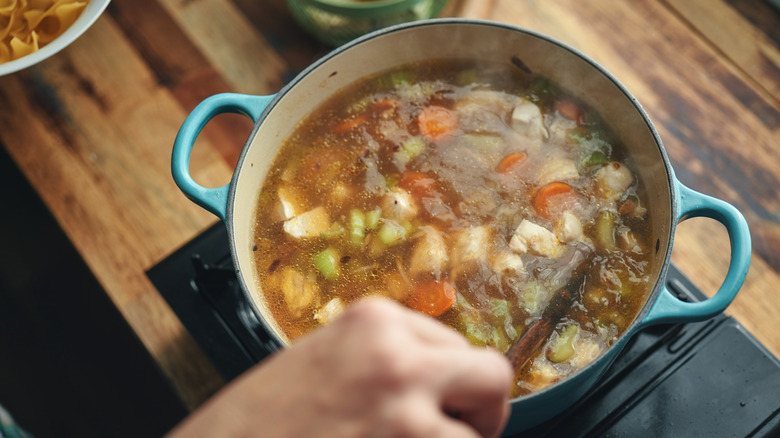 chicken noodle soup in a blue pot