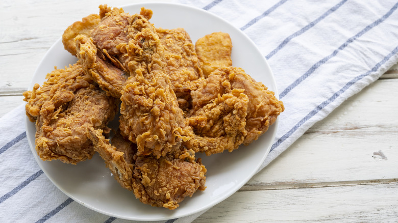 Plate of fried chicken on wooden table