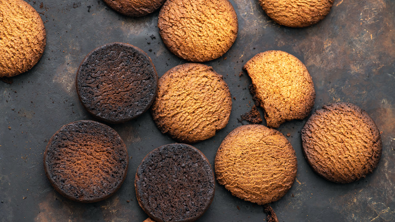 Cookies on a baking sheet with burnt bottoms