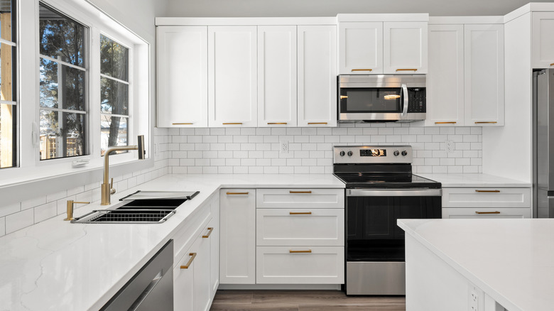 Clean white minimalistic kitchen with lots of sunlight