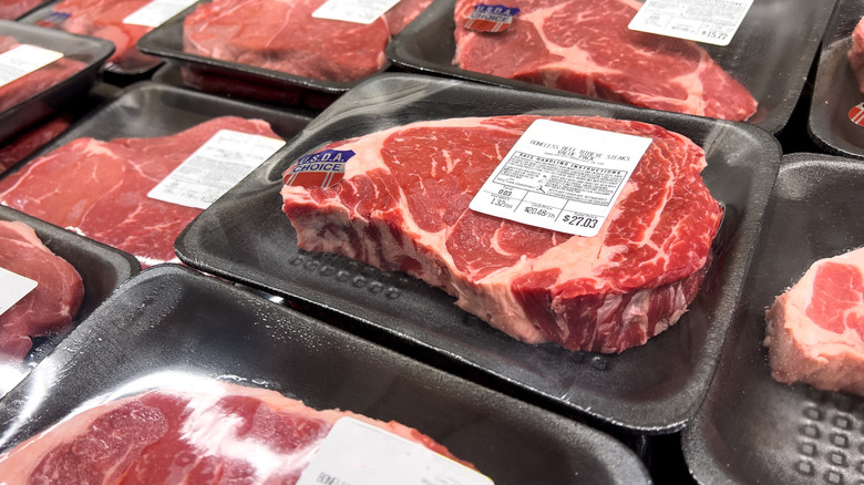 Individually-wrapped USDA beef steaks in grocery store display