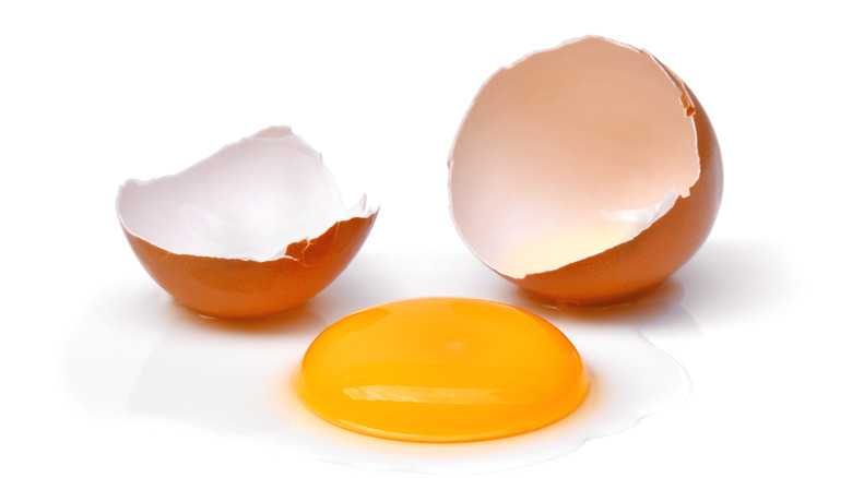 A cracked egg with a perfect yolk