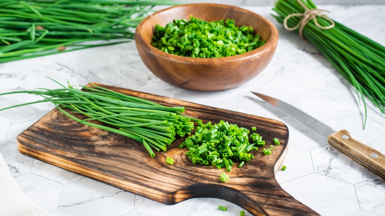 cutting chives on wood board