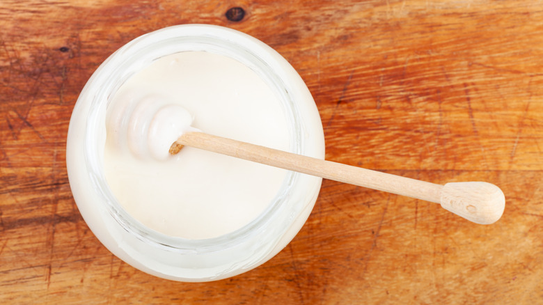white honey with spoon
